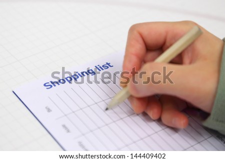 Woman writing shopping list for xmas
