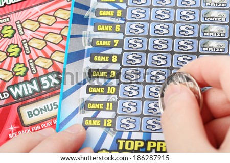 Coquitlam BC Canada - March 26 2014 : Scratching a lottery ticket. The British Columbia Lottery Corporation has provided government sanctioned lottery games in British Columbia since 1985.