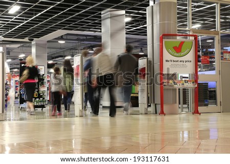 Coquitlam BC Canada - May 10, 2014 : People shopping in future shop store with motion blur inside Coquitlam Center mall on May 10, 2014.