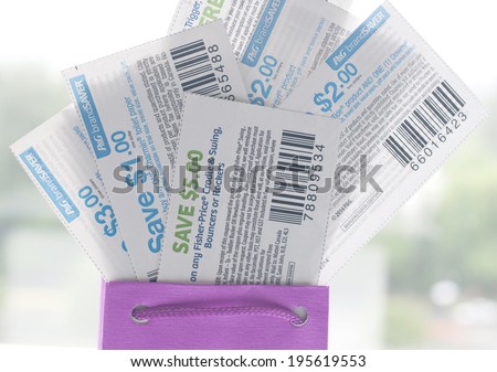 Coquitlam, BC, Canada - May 25, 2014 : Close up coupons inside gift bag. All coupons for Canadian store, they are issued by manufacturers of consumer packaged goods or by retailers in Canada.