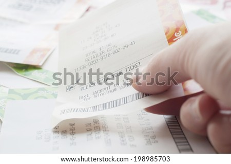 Coquitlam BC Canada - May 31, 2014 : Close up people holding a winning lottery ticket. The BC Lottery Corporation has provided government sanctioned lottery games in British Columbia since 1985.