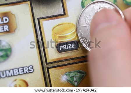 Coquitlam BC Canada - June 15, 2014 : Woman scratching lottery ticket called lucky 7. It\'s published by BC Lottery Corporation has provided government sanctioned lottery games.