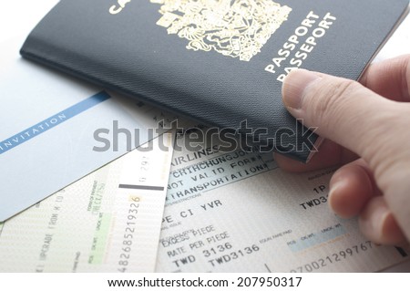 Holding Canada passport with boarding pass