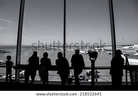 Vancouver, BC Canada - September 13, 2014 : People inside YVR airport watching air canada airplane in Vancouver BC Canada.
