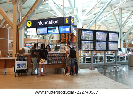 Vancouver, BC Canada - September 13, 2014 : People asking some information insdie the YVR airport in Vancouver BC Canada.