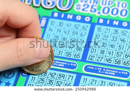 Coquitlam BC Canada - June 15, 2014 : Woman scratching lottery tickets. The British Columbia Lottery Corporation has provided government sanctioned lottery games in British Columbia since 1985.
