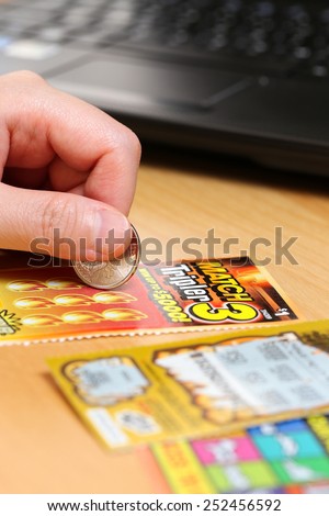 Coquitlam BC Canada - June 15, 2014 : Woman scratching lottery tickets. The British Columbia Lottery Corporation has provided government sanctioned lottery games in British Columbia since 1985.