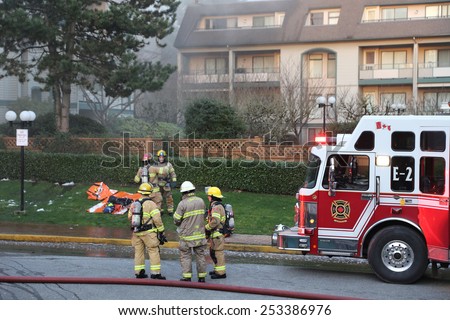 Coquitlam, BC, Canada - February 16, 2015 : Firefighter crews battling apartment complex fire on Glen drive in Coquitlam.