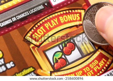 Coquitlam BC Canada - February 05, 2015 : Woman scratching lottery tickets. The British Columbia Lottery Corporation has provided government sanctioned lottery games in British Columbia since 1985.