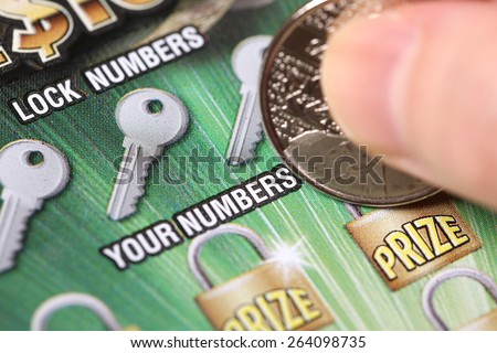 Coquitlam BC Canada - March 21, 2015 : Woman scratching lottery tickets. The British Columbia Lottery Corporation has provided government sanctioned lottery games in British Columbia since 1985.