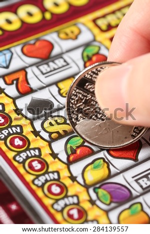 Coquitlam BC Canada - February 05, 2015 : Woman scratching lottery tickets. The British Columbia Lottery Corporation has provided government sanctioned lottery games in British Columbia since 1985.
