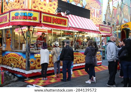 Coquitlam, BC, Canada - April 10, 2015 : Peopke line up for buying food at the West Coast Amusements Carnival