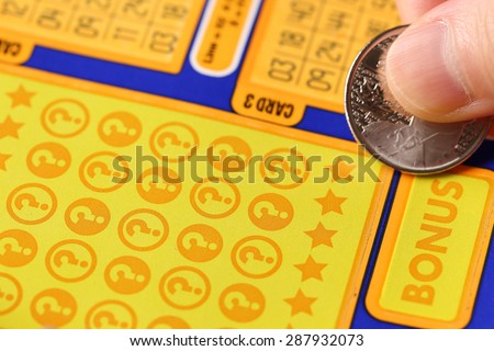 Coquitlam BC Canada - June 02, 2015 : Woman scratching lottery ticket. The British Columbia Lottery Corporation has provided government sanctioned lottery games in British Columbia since 1985.