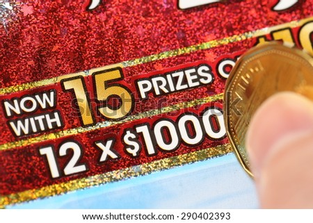 Coquitlam BC Canada - June 04, 2015 : Woman scratching lottery ticket. The British Columbia Lottery Corporation has provided government sanctioned lottery games in British Columbia since 1985.