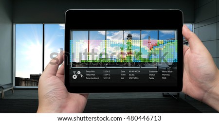 Industry 4.0 concept .Man hand holding tablet with Augmented reality screen and  oil refinery in smart factory.Window showing oil refinery industry background