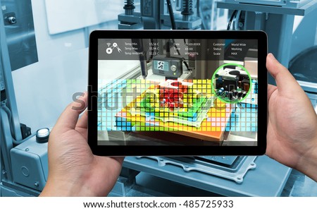 Industry 4.0 concept .Man hand holding tablet with Augmented reality screen software and blue tone of automate wireless Robot arm in smart factory background