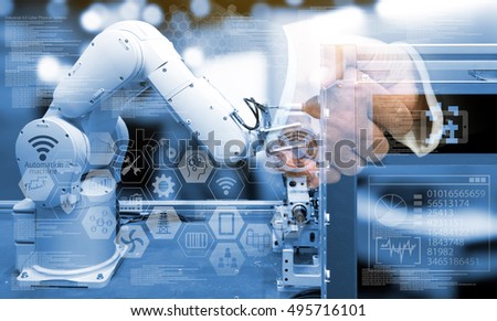 Industry 4.0 concept .Two Business people shaking hands with industry graphic sign and blue tone of automate wireless Robot arm in smart factory background. Double exposure ,blue tone
