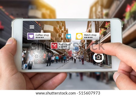 Augmented reality marketing concept. Hand holding smart phone use AR application to check relevant information about the spaces around customer. City and flare light background