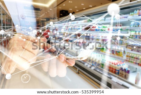 Deep learning , Neural networks , Machine learning and artificial intelligence concept. Atom connect with hand holding mobile phone and blur retail shop store background