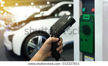 Electric vehicle charging station for home with EV car background , Flare light