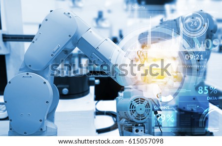 Industrial internet of things and industry 4.0 concept. Abstract blue background of technology graphic and automation wireless control robotic machine in smart factory with flare light effect.