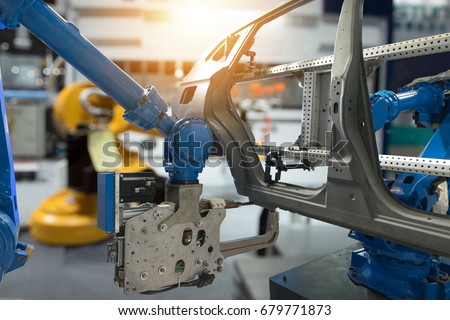 Automobile manufacturing production industrial machine , factory robot arm in smart factory and industry 4.0 concept. Flare light effect.