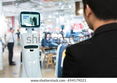 Robotics Trends technology , smart retail business concept. Autonomous personal assistant robot for navigation customer to search items in fashion shopping mall.
