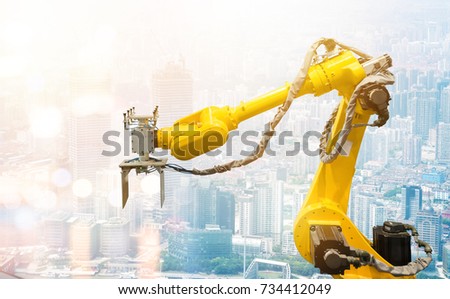 Heavy automation robot arm machine in smart factory industrial. Industry 4th iot and smart logistic , construction  concept with abstract blur bokeh building background. Flare light effect.