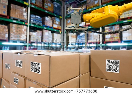 Smart logistic industry 4.0 , QR Codes Asset warehouse and inventory management supply chain technology concept. Group of boxes and Automation robot arm machine in storehouse.