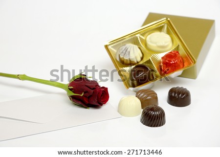 Present with letter, red rose and chocolate