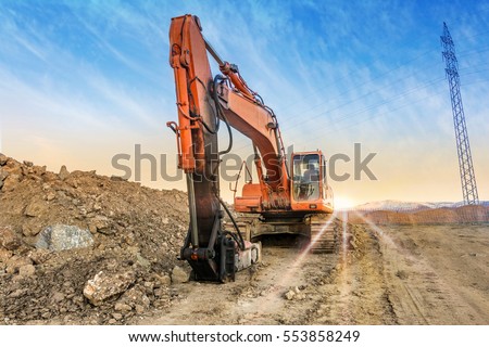Earth moving by a bulldozer in the construction of a road in Spain. Hydraulic hammer for backhoe