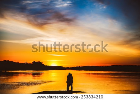 Couple Man and Woman Hugging in Love staying on Beach seaside with Sunset