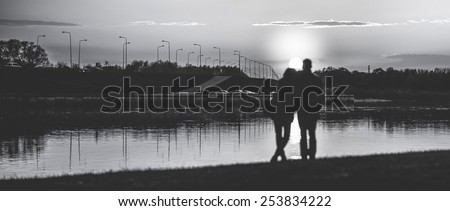 Couple Man and Woman Hugging in Love staying on Beach seaside with Sunset, edited in black and white