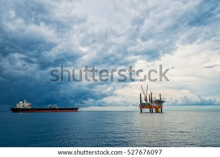 Oil Platform and Tanker in the Sea.the sky is dim.