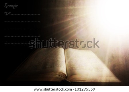 holy light over the old book; vintage textured background with space for sample text