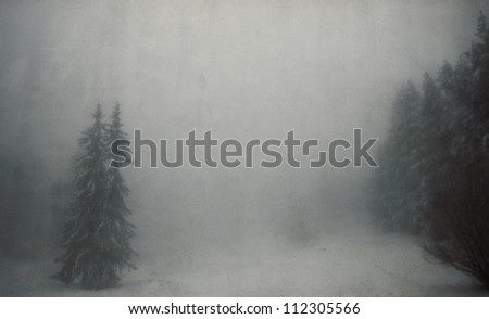 vintage winter landscape with spooky tree in fogy forest