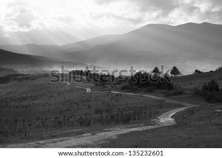black and white landscape with old countryside road near mountain city in bulgaria