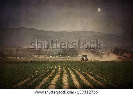 vintage agriculture industrial background in dusk time with rising moon