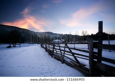 low light winter sunset landscape with small house in bulgarian farmland