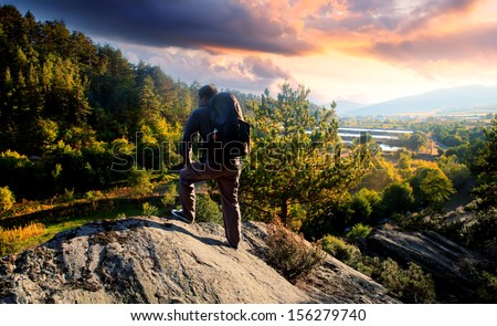 young mountainer look in to beautiful colorful sunset- HDR adventure landscape
