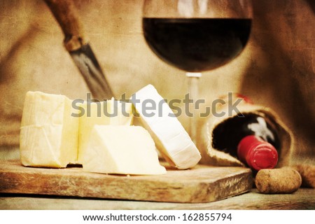 vintage still-life textured background with red wine and cheese