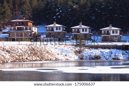 winter over the eco village resort near lake in bulgaria