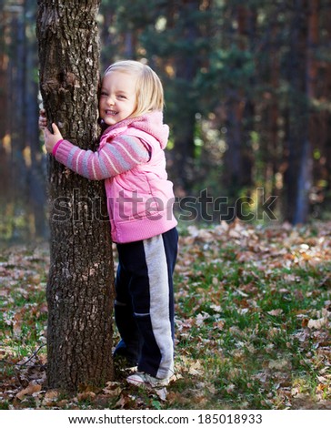 happy cute girl child in tree hug