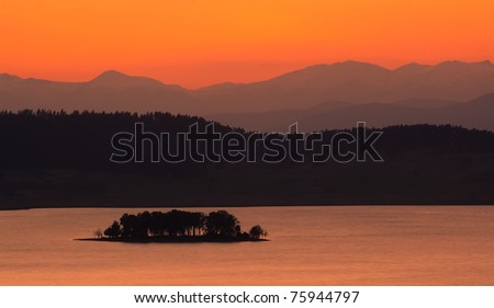 golden nature panorama with lake in dusk time