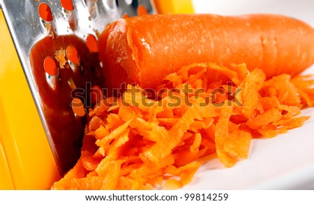 grater and fresh carrot macro shot suitable for restaurant menu