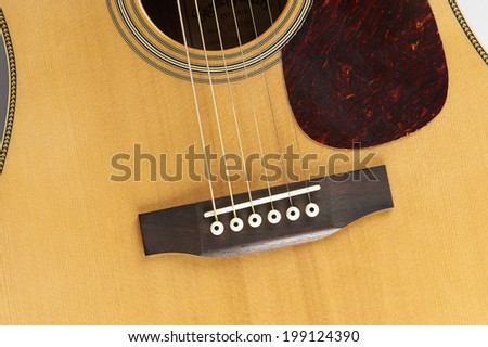 a detail of an acoustic guitar  in white background