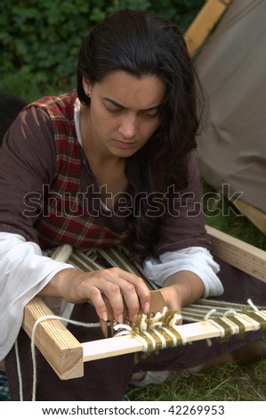 BRESCIA , ITALY - JULY 13: An unidentified woman at work on an ancient Celtic wool spinner at Celtic Day celebration July 13, 2008 in Brescia, Italy