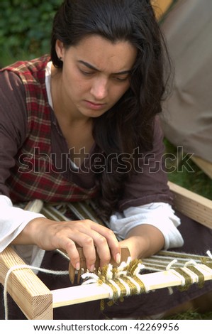 BRESCIA , ITALY - JULY 13: An unidentified woman at work on an ancient Celtic wool spinner at Celtic Day celebration July 13, 2008 in Brescia, Italy