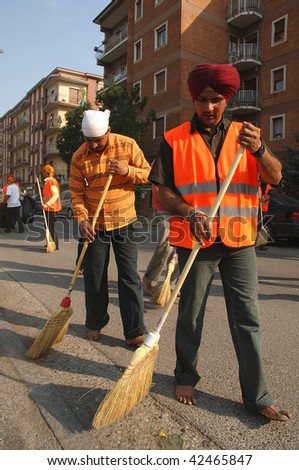 BRESCIA, ITALY - APRIL 30: Street cleaners sweep street before 'Baisakhi' procession April 30, 2005 in Brescia, Italy.  20,000 Sikh Indians residing in Italy celebrate the annual procession.