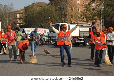 BRESCIA, ITALY - APRIL 30: Street cleaners sweep street before \'Baisakhi\' procession April 30, 2005 in Brescia, Italy.  20,000 Sikh Indians residing in Italy celebrate the annual procession.